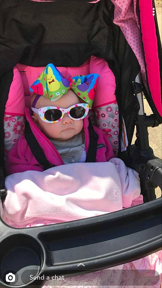 Braylee is registered to the contest to win money with this photo: baby_carriage, cool, diaper_bag, eyewear, glasses, headwear, magenta, person, pink, sunglasses, vision_care