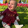 baby, child, smiling, grass, tulips, flowers, outdoor, sunlight, nature, park, person, dress, leggings, sock, tree, building, happy, portrait, spring, colorful
