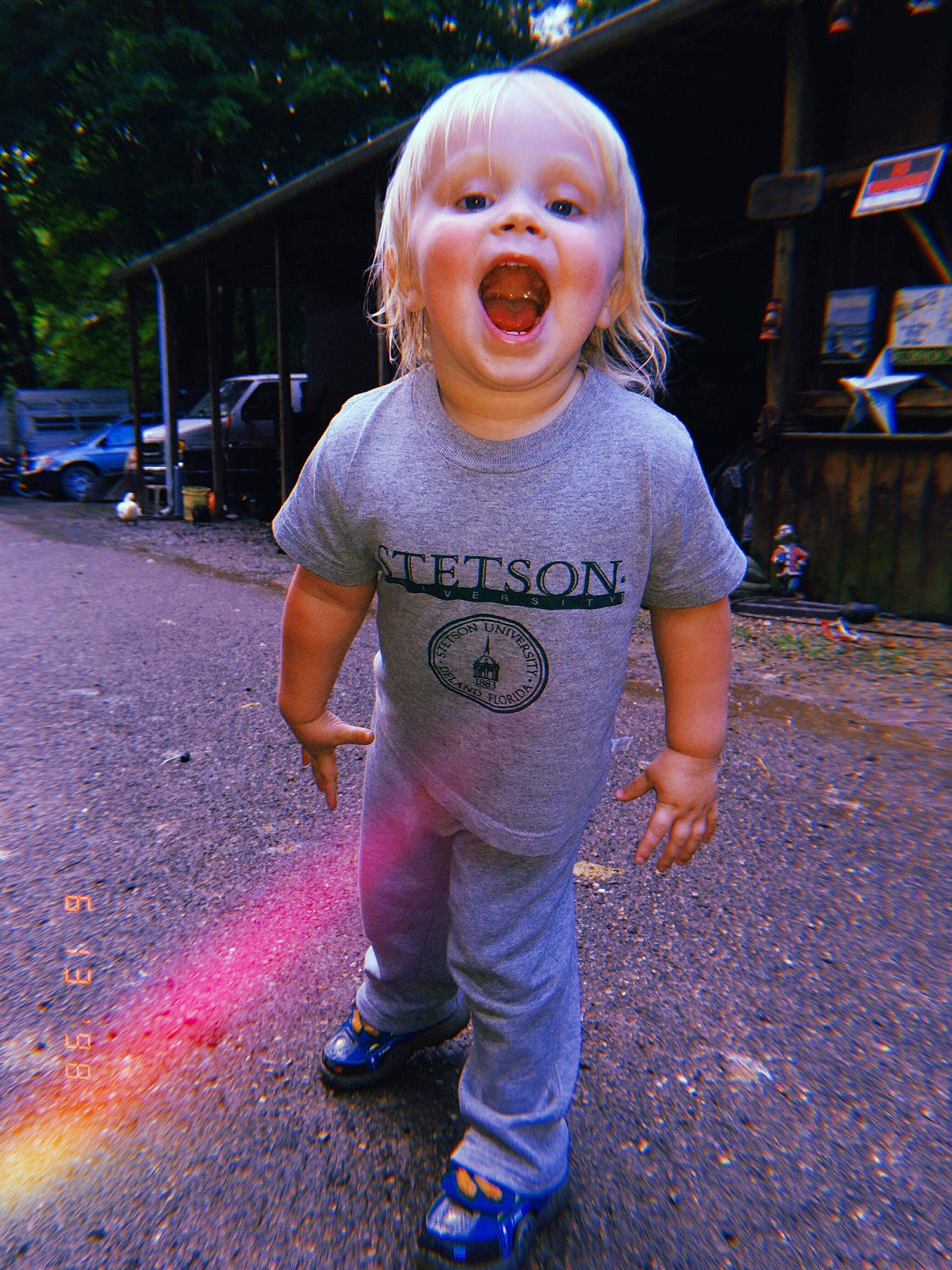 Carl is registered to the contest to win money with this photo: child, cool, facial_expression, fun, happy, head, human, laugh, person, pink, play, public_space, purple, road_surface, skin, sleeve, smile, standing, t_shirt, toddler