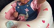 Alayah is registered to the contest to win money with this photo: baby, infant, child, pink_bow, headband, denim_overall, elephant_embroidery, inflatable_seat, heart_pattern, candy_pattern, reaching_hand, cute, adorable, indoors, couch, soft_lighting, portrait, sitting, expression, young_child