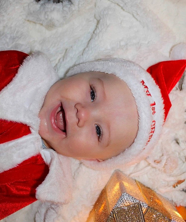 Baylor joined the competition — help win amazing prizes! baby, baby_toddler_clothing, bonnet, carmine, cheek, child, christmas, costume_accessory, facial_expression, fictional_character, fur, fur_clothing, headwear, human, linens, lip, person, pleased, red, textile