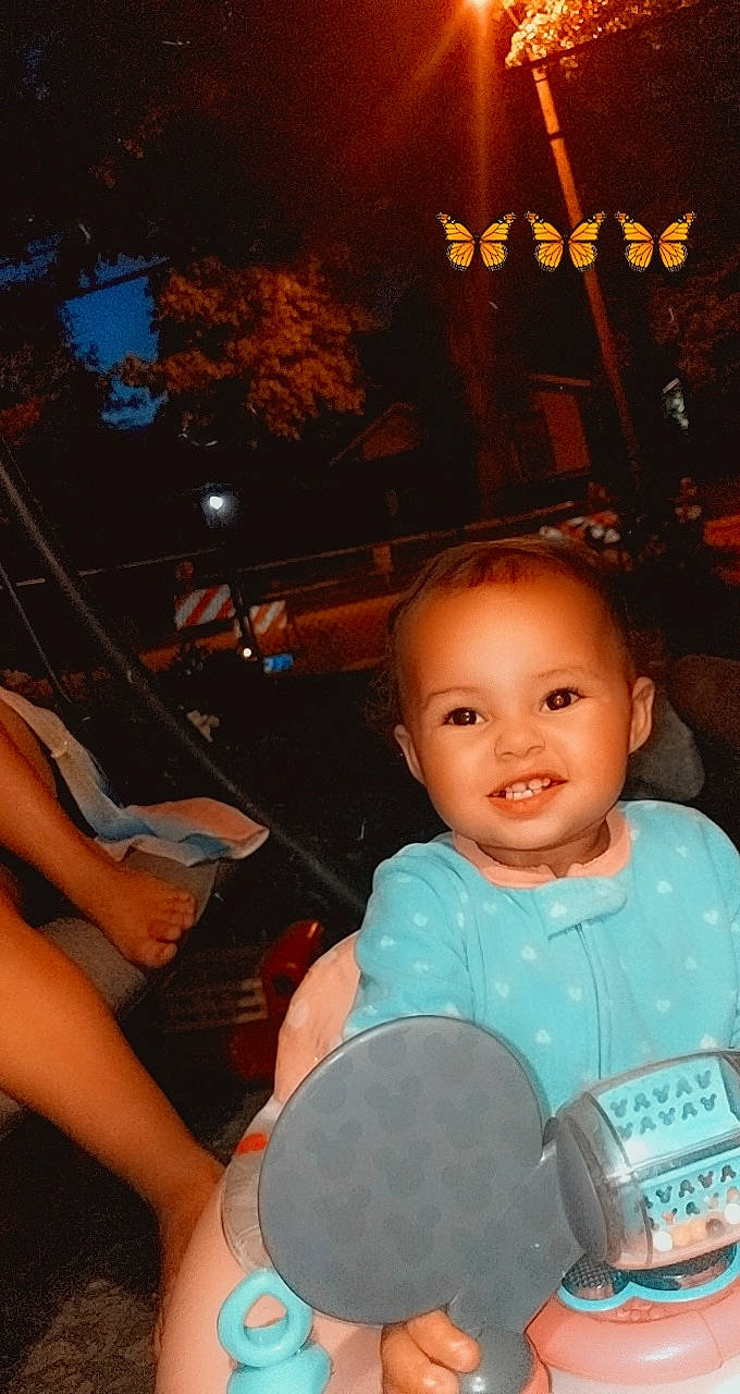 Journee is registered to the contest to win money with this photo: baby, child, cool, event, flash_photography, fun, hand, happy, human_leg, joy, laugh, leisure, midnight, night, person, sitting, smile, t_shirt, thigh, toddler