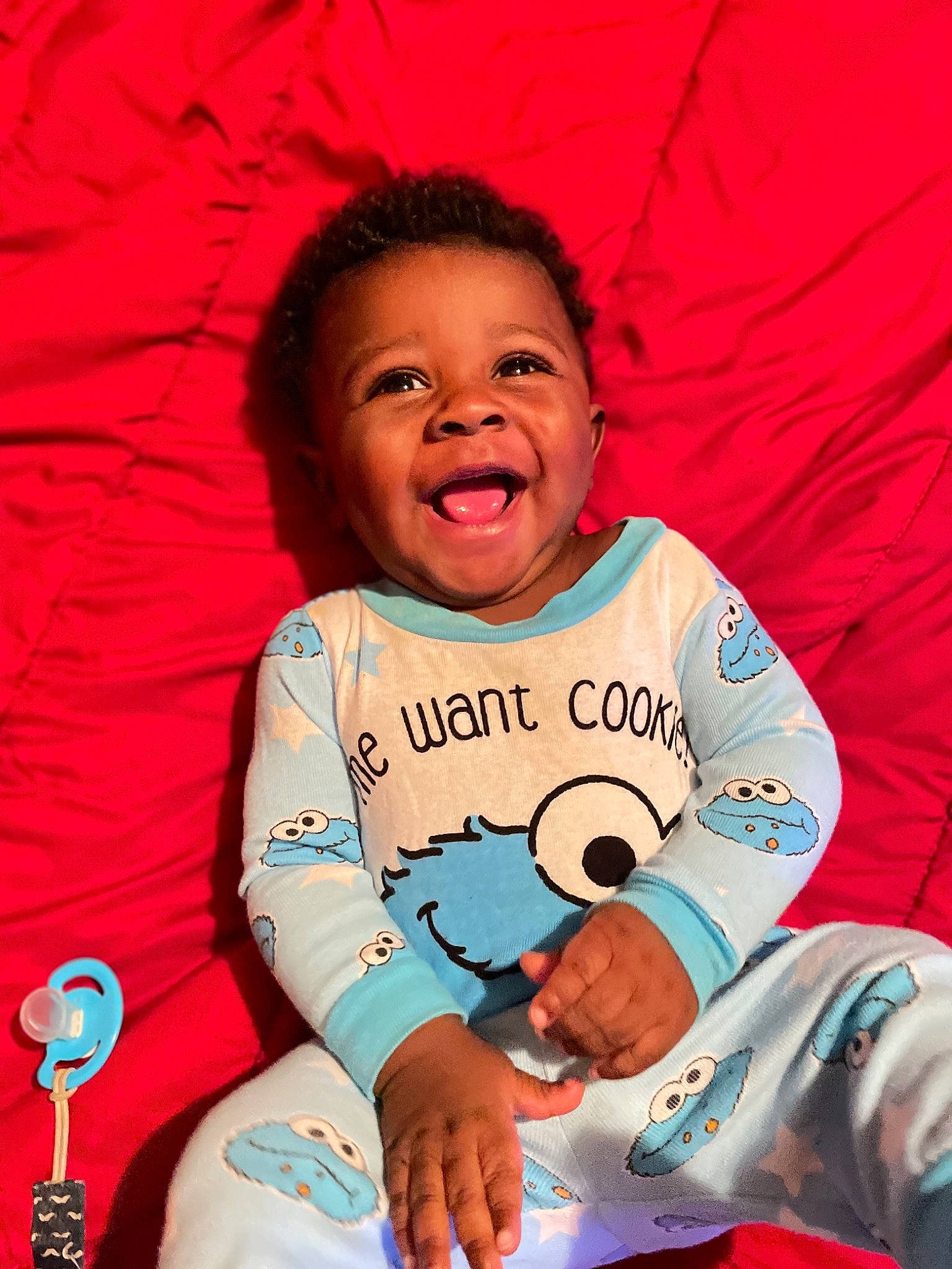 Kashton is registered to the contest to win money with this photo: arm, baby_toddler_clothing, cheek, eye, face, facial_expression, gesture, hairstyle, hand, happy, head, human, human_body, mouth, nose, person, pink, skin, sleeve, smile