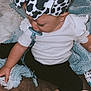 baby, child, pacifier, headband, bow, blanket, clothing, sitting, indoors, cute, infant, black_pants, white_shirt, baby_bottle, footwear, toy, soft_texture, curly_hair, sleep_aid, comfort