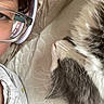 Fluffy joined the competition — help win amazing prizes! person, glasses, cat, pet, sleeping, close_up, fur, whiskers, bed, mattress, fabric, relaxation, indoor, companion, resting, nap, cozy, human, eyewear, head