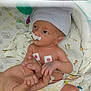 newborn, baby, hospital, medical_equipment, hand, finger, diaper, beanie, sensor, monitoring, patient, infant, skin, person, care, holding, bed, cute, healthcare, tiny