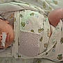 Caspen joined the competition — help win amazing prizes! newborn, baby, hospital, blanket, swaddle, cap, medical_tape, tube, sleeping, infant, bed, crib, pattern, cute, face, person, healthcare, resting, child, wrapped