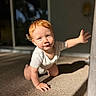 baby, carpet, child, crawling, curious, expression, floor, home, indoor, light, natural_light, onesie, person, portrait, reaching, red_hair, shadow, skin, toddler, young_child