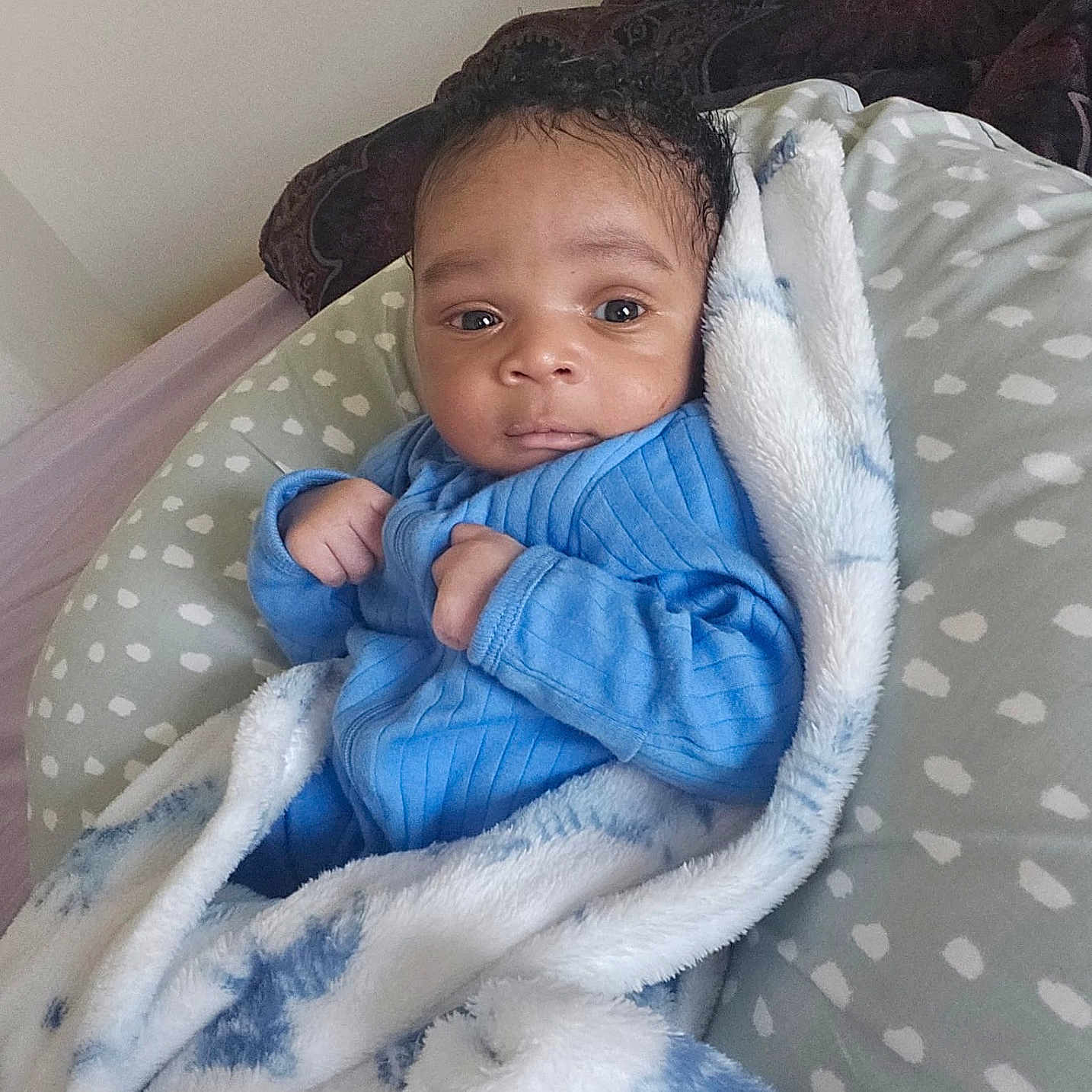 Esosa is registered to the contest to win money with this photo: baby, bed, bedroom, blanket, crib, cushion, face, furniture, happy, head, homedecor, indoors, infantbed, newborn, person, photography, portrait, quilt, room, smile