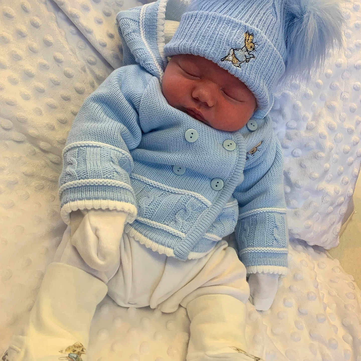 Kristian is registered to the contest to win money with this photo: baby, bed, blanket, bonnet, cap, clothing, coat, face, furniture, glove, hat, head, hosiery, jacket, newborn, person, photography, portrait, sleeping, sock