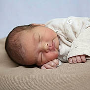 Nicolas participe au concours pour gagner de l'argent avec cette photo : baby, newborn, sleeping, infant, cozy, cushion, knitted, soft, peaceful, face, hand, clothing, onesie, rest, child, portrait, indoors, cute, closeup, relaxation