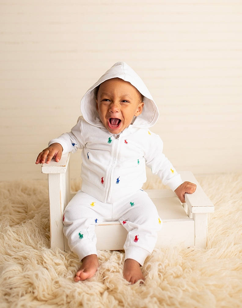 Kai'Sen is registered to the contest to win money with this photo: baby, baby_toddler_clothing, cap, child, collar, comfort, eye, face, fun, fur, happy, hat, head, headwear, outerwear, person, portrait_photography, sitting, sleeve, smile