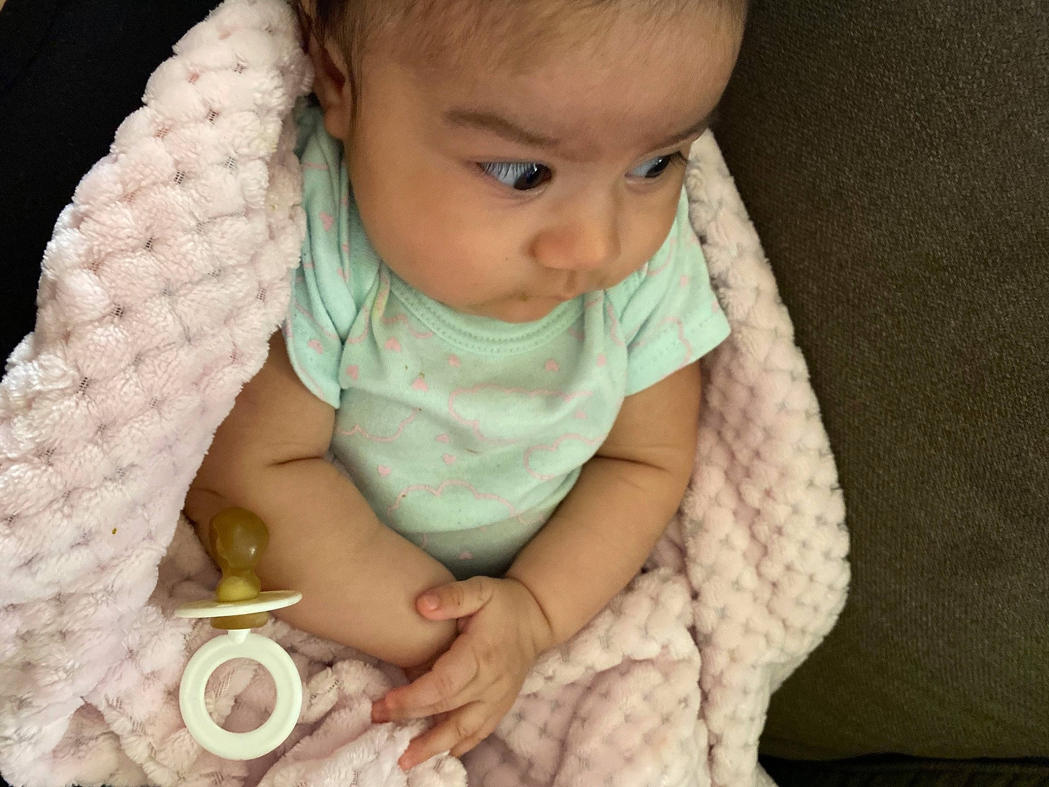 Romina is registered to the contest to win money with this photo: arm, baby, baby_toddler_clothing, cheek, chin, comfort, eye, eyebrow, finger, gesture, hand, iris, lip, mouth, nail, nose, organ, person, skin, sleeve