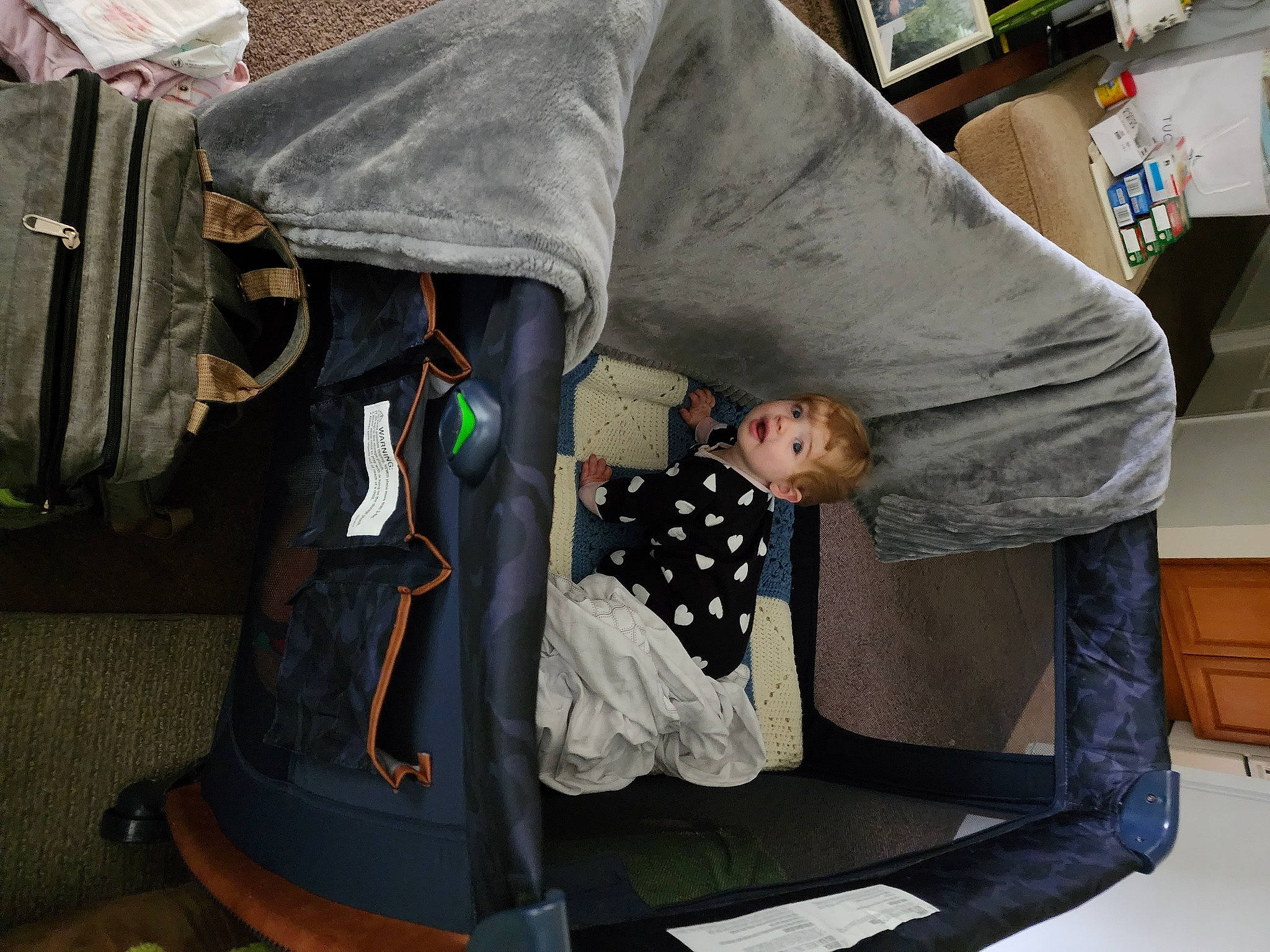 Olivia is registered to the contest to win money with this photo: baby_carriage, baby_products, baby_safety, baby_toddler_clothing, bag, baggage, car_seat, child, comfort, fashion_accessory, infant_bed, leisure, linens, luggage_and_bags, nap, person, room, sitting, suitcase, surprise