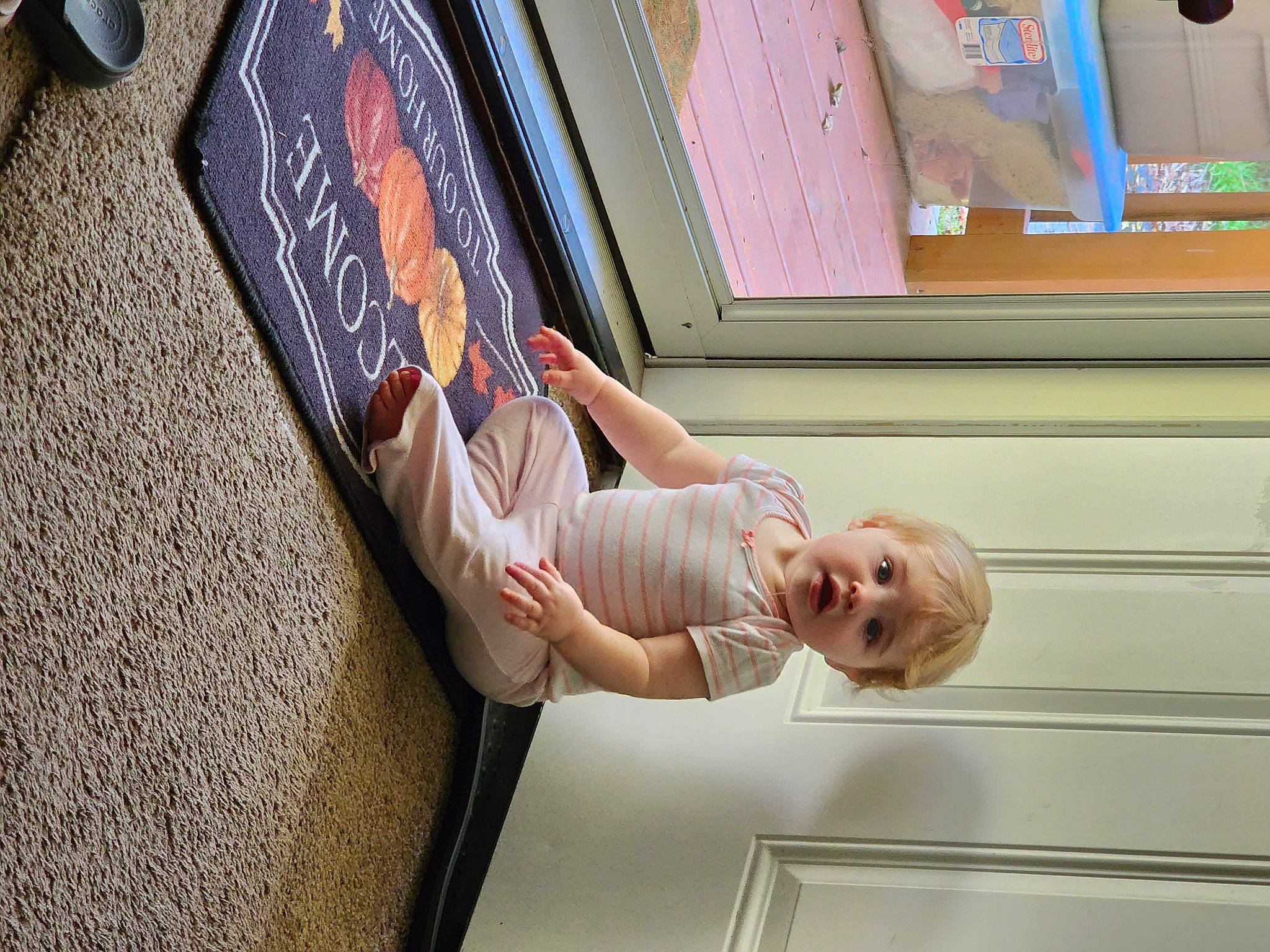 Olivia is registered to the contest to win money with this photo: art, comfort, elbow, flooring, fun, gesture, happy, human_leg, joint, knee, leg, leisure, person, room, sitting, smile, thigh, toddler, visual_arts, window