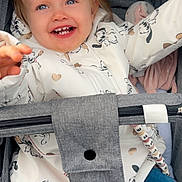 Charlize participe au concours pour gagner de l'argent avec cette photo : baby_hair_clip, blue_eyes, cartoon_print, child, clothing, cute, gray, happy, infant, jacket, jeans, joyful, outdoor, person, playful, portrait, seated, smiling, stroller, toddler