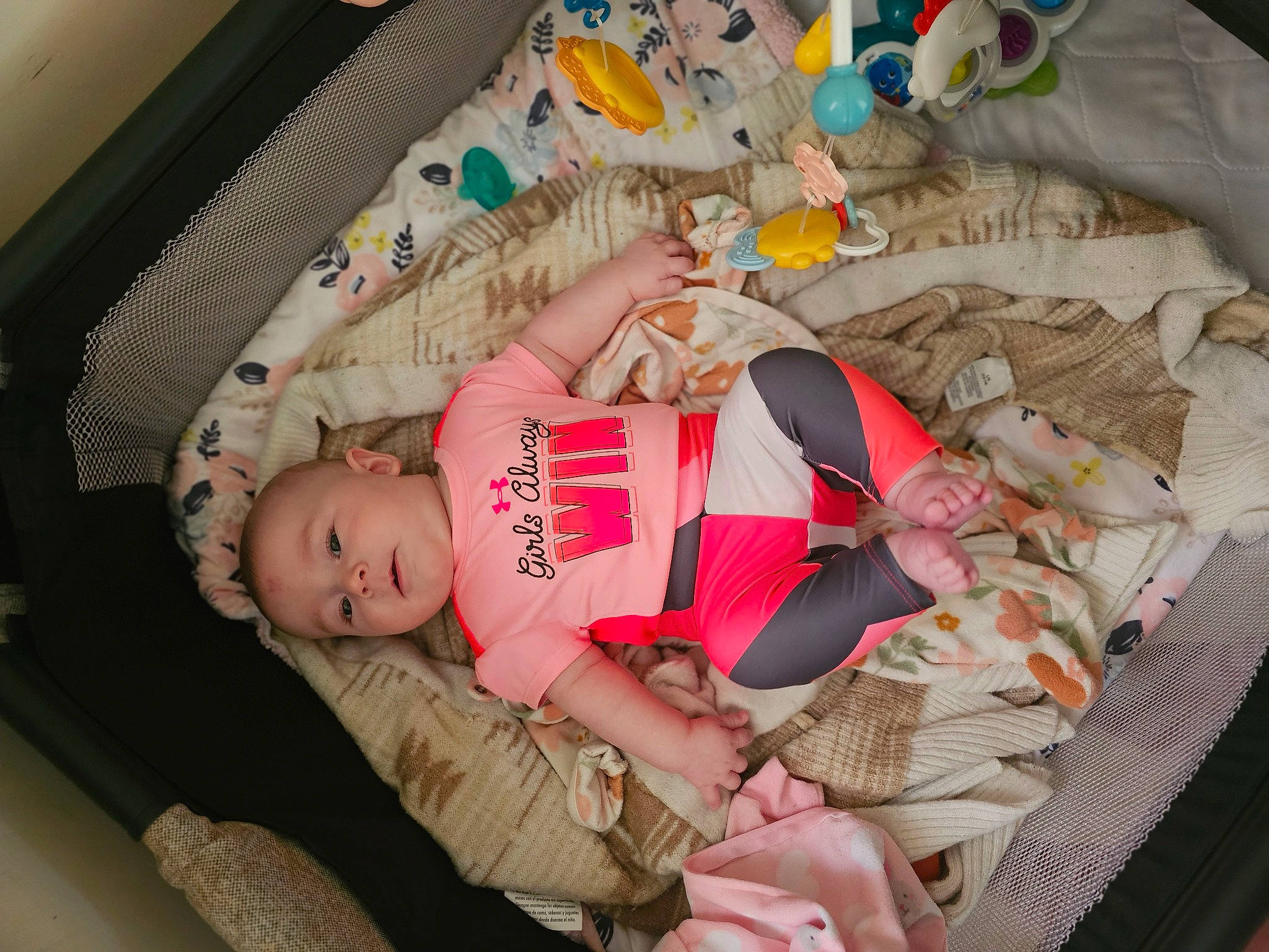 Rhiannon is registered to the contest to win money with this photo: arm, baby, baby_products, baby_toddler_clothing, bedtime, child, comfort, foot, fun, human_leg, lap, linens, nail, nap, pattern, person, room, sitting, sock, thigh