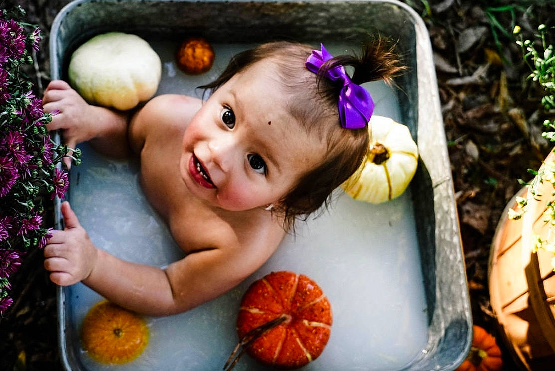 Esme is registered to the contest to win money with this photo: calabaza, cucurbita, doll, eye, facial_expression, fawn, gourd, grass, happy, iris, mouth, natural_foods, orange, people_in_nature, person, plant, pumpkin, smile, toy, winter_squash