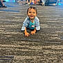 Theodore joined the competition — help win amazing prizes! toddler, child, crawling, smiling, indoor, carpet, name_tag, person, happy, floor, clothing, face, head, people, blurred_background, furniture, shoes, jeans, jacket, room