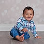 Theodore is registered to the contest to win money with this photo: baby, background_blur, barefoot, blue_pants, blue_shirt, casual_clothing, caucasian, child, cute, face, happy, indoor, person, plaid, portrait, sitting, smiling, toddler, wooden_floor, young_child