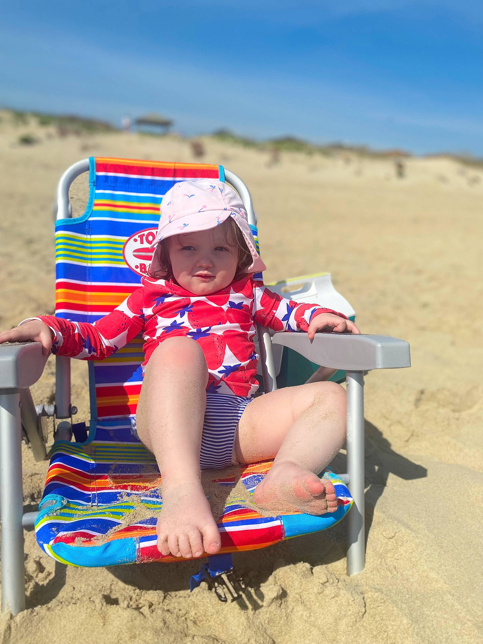 Sawyer joined the competition — help win amazing prizes! beach, chair, fun, happy, hat, headgear, headwear, landscape, leisure, outdoor_furniture, outdoor_recreation, people_in_nature, people_on_beach, person, recreation, sand, shorts, sky, sun_hat, sun_tanning