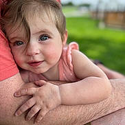 Vivienne Walter is registered to the contest to win money with this photo: baby, child, face, arms, skin, hair, outdoor, greenery, person, holding, hug, closeup, portrait, infant, cute, smile, toddler, human, warmth, comfort
