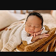 Rylan is registered to the contest to win money with this photo: newborn, baby, sleeping, blanket, cushion, wooden_bed, cozy, soft, infant, peaceful, wrapped, knitted_blanket, cute, portrait, indoors, resting, tiny_hands, sleep, warm, peace