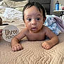 Rylan joined the competition — help win amazing prizes! baby, infant, three_months, bed, quilt, plush_toy, elephant_toy, hand, sign, milestone, wide_eyes, curious, skin, face, arms, fingers, indoor, cozy, blanket, person