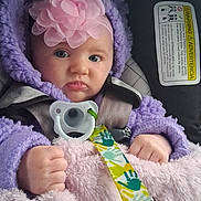 Willow joined the competition — help win amazing prizes! baby, blanket, blue_eyes, car_seat, child, closeup, clothing, cozy, facial_expression, flower_headband, hands, headband, hooded_jacket, infant, pacifier, portrait, purple, safety_label, seat_belt, soft_blanket