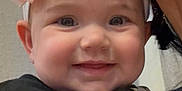 Everleigh joined the competition — help win amazing prizes! baby, child, smiling, pink_bow, headband, face, person, adult, holding, close_up, cute, happy, indoor, clothing, black_shirt, blue_jeans, skin, eyes, portrait, dimple