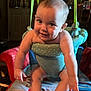 baby, smiling, indoor, baby_jumper, child, cute, infant, play, furniture, blanket, paw_patrol, footwear, happy, person, seat, toy, room, childhood, arms, legs