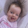 baby, child, smiling, blue_eyes, pink_clothing, tongue_out, soft_toys, plush, infant, cute, portrait, happy, indoors, baby_seat, close_up, human, face, head, toddler, cozy