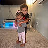 Jaden joined the competition — help win amazing prizes! toddler, child, hug, smile, indoor, carpet, living_room, clothing, barefoot, girl, boy, family, cute, adorable, home, playful, happy, person, sibling, affection