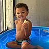 toddler, child, pool, water, blue, smile, food, bread, indoor, curtain, light, shadow, skin, hair, sitting, play, fun, happy, summer, clothing