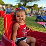 Jaycie joined the competition — help win amazing prizes! toddler, child, smiling, red_wagon, bow, hair_accessory, outdoor, grass, park, sunlight, happy, seatbelt, red_clothing, playtime, curly_hair, people, daylight, nature, childhood, fun