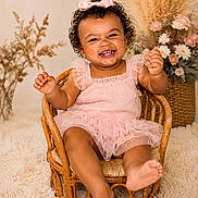 Jaycie joined the competition — help win amazing prizes! baby, basket, bow, carpet, child, cozy, curly_hair, cute, decor, floral_arrangement, fun, happy, indoor, pink_dress, portrait, sitting, smiling, toddler, wicker_chair, young_child