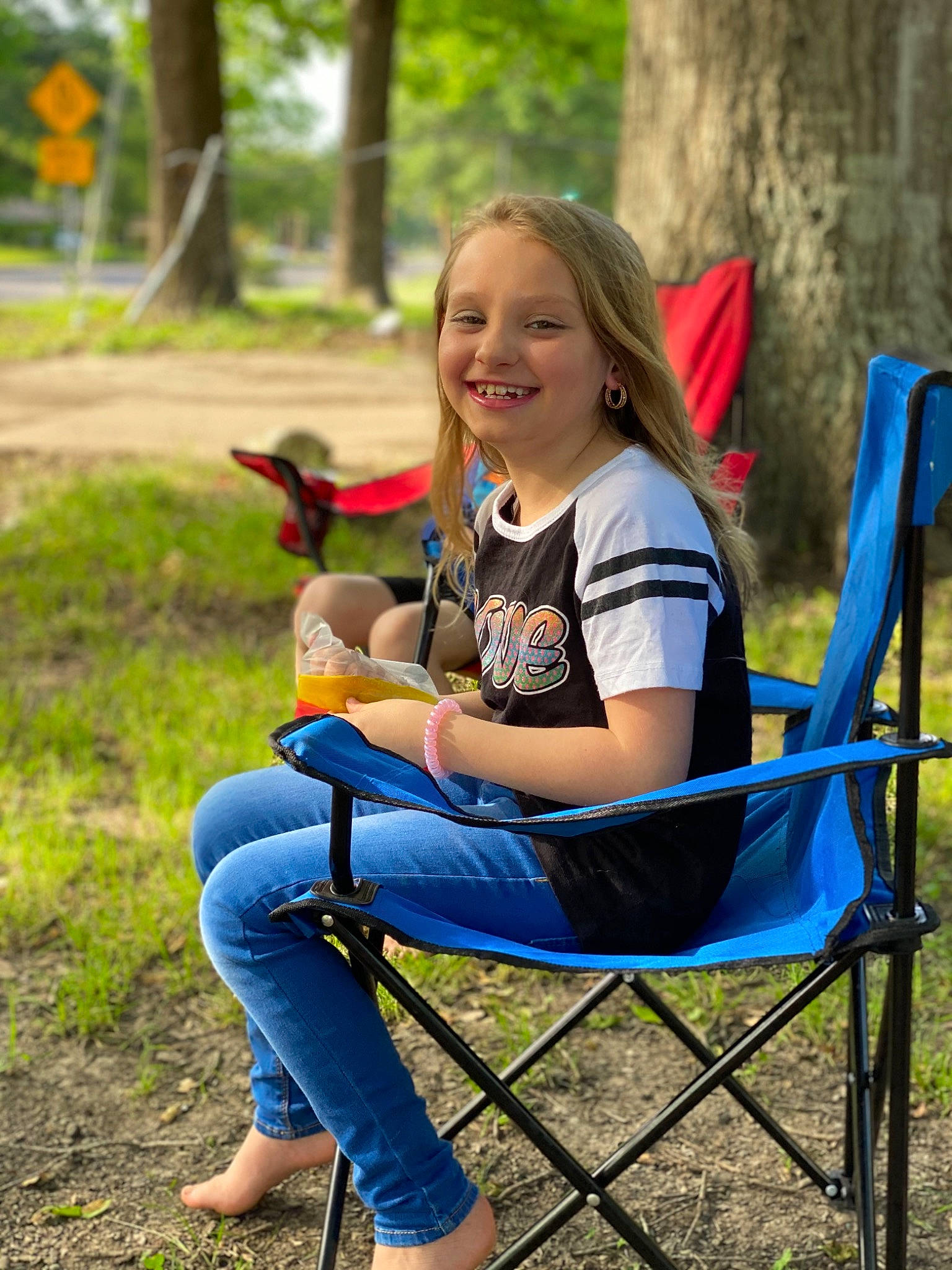 Hayley is registered to the contest to win money with this photo: botany, child, furniture, grass, happy, jeans, joy, leaf, leisure, people, person, plant, play, recreation, sitting, smile, style, summer, table, toddler