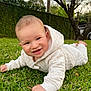 baby, child, grass, outdoor, hoodie, white_clothing, smile, crawling, greenery, tree, nature, daylight, face, person, infant, quilted_fabric, park, cute, young_child, garden