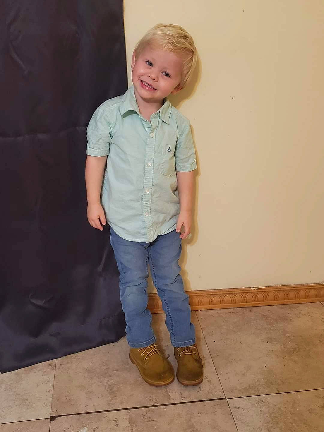 Mason is registered to the contest to win money with this photo: baby_toddler_clothing, collar, denim, dress_shirt, electric_blue, eye, face, flooring, gesture, human_body, jeans, joy, knee, leg, neck, pattern, person, sleeve, smile, t_shirt