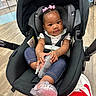 Janayah joined the competition — help win amazing prizes! baby, car_seat, casual, chairs, child, clothing, curly_hair, cute, floor, flooring, footwear, indoor, infant, person, pink_bows, playful, portrait, seatbelt, shoe, sparkly