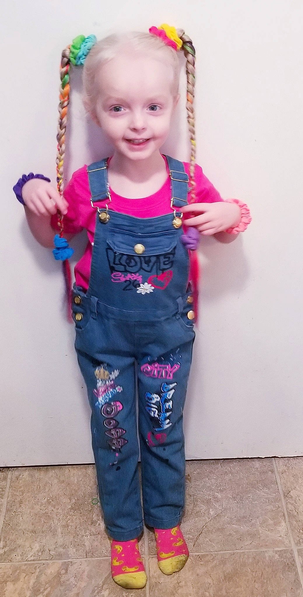 Alexandria is registered to the contest to win money with this photo: arm, baby, baby_toddler_clothing, clothing, electric_blue, gesture, happy, human_body, joy, magenta, neck, outerwear, person, pink, purple, shoulder, sleeve, smile, t_shirt, textile
