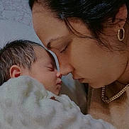 Aitana is registered to the contest to win money with this photo: baby, newborn, mother, face, profile, skin, love, affection, bond, family, closeup, cuddle, blanket, indoor, warmth, portrait, sleeping, head, earring, necklace