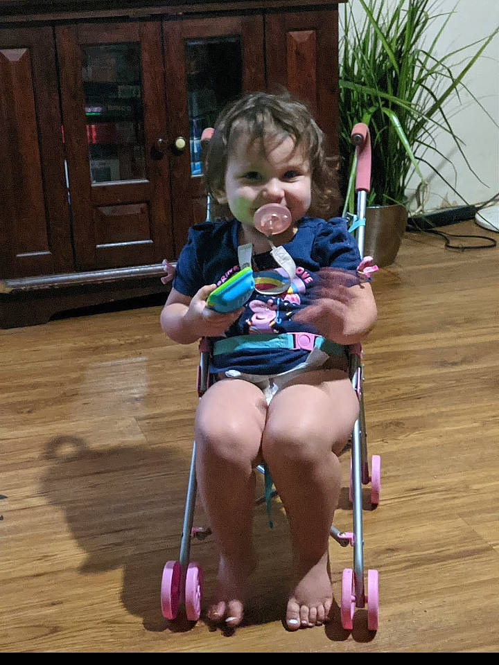 Adriana joined the competition — help win amazing prizes! cabinetry, chair, child, door, flowerpot, fun, furniture, grass, hardwood, houseplant, leg, leisure, person, plant, recreation, sitting, skin, smile, thigh, toddler