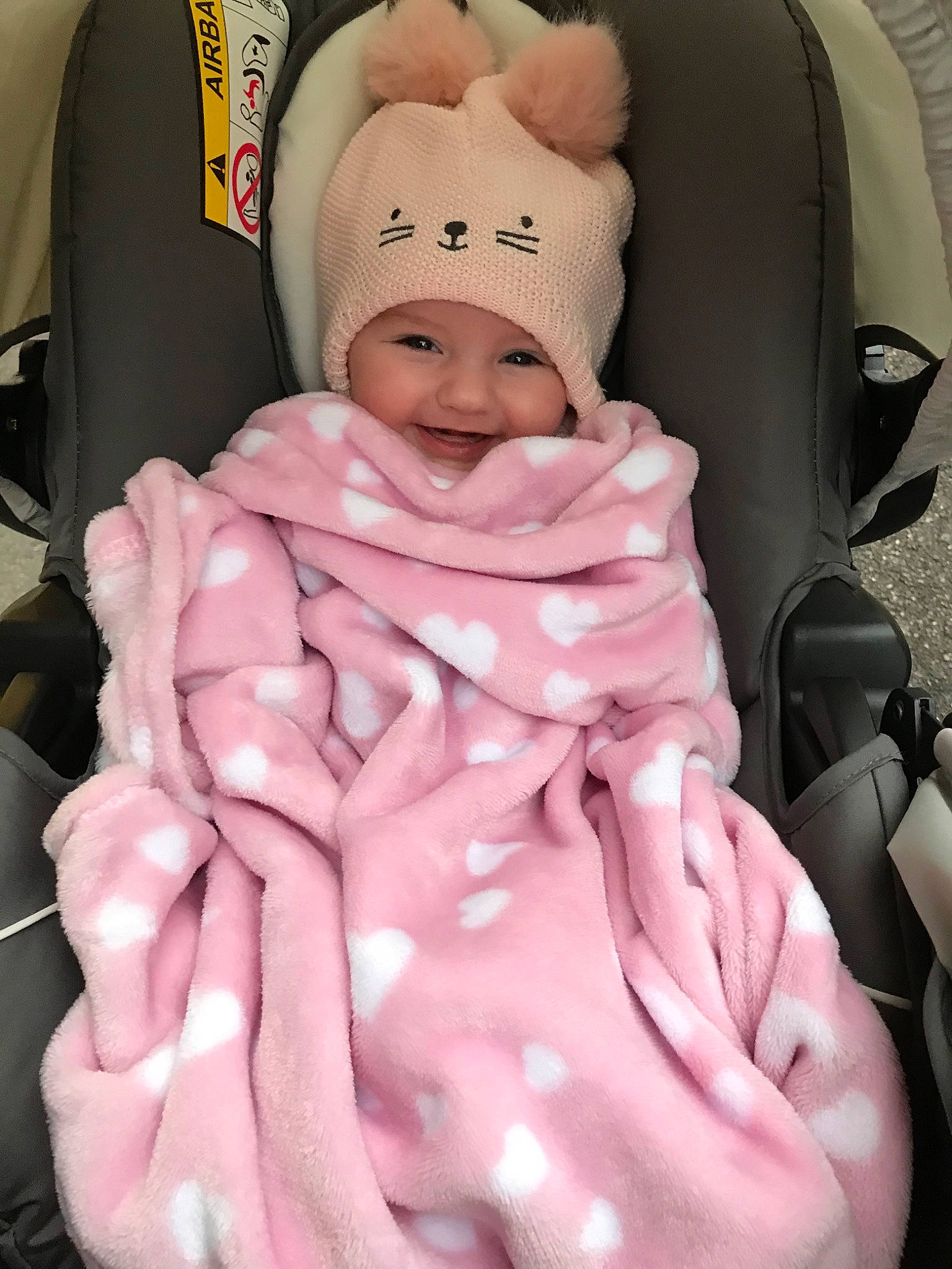 Mélody participe au concours pour gagner de l'argent avec cette photo : baby, baby_carriage, baby_products, car_seat, cheek, child, head, headwear, joy, person, pink, product, smile, toddler