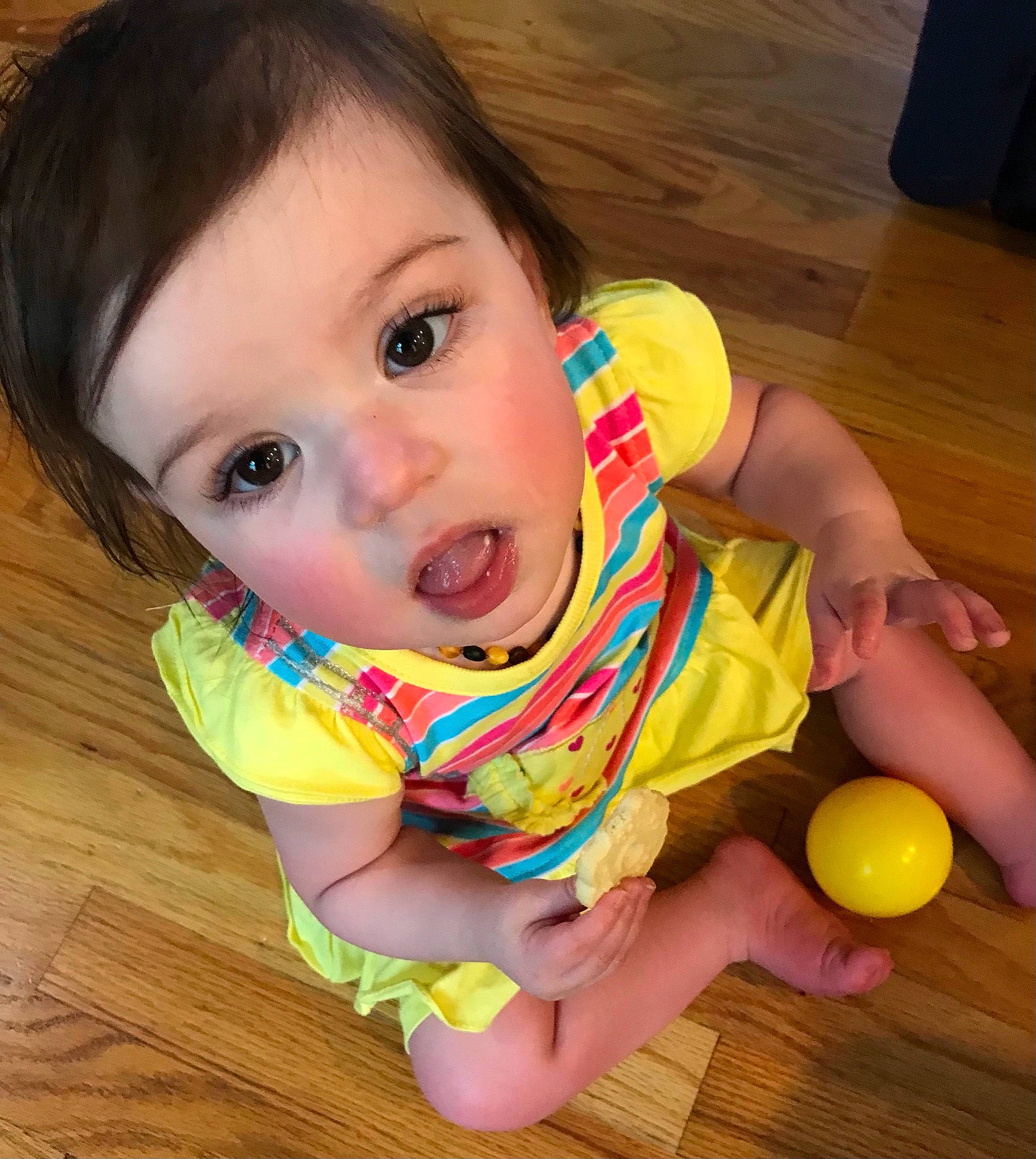 Brooklyn is registered to the contest to win money with this photo: baby, baby_toddler_clothing, balloon, cheek, child, eyelash, facial_expression, finger, floor, flooring, fun, happy, hardwood, iris, nose, person, skin, sleeve, surprise, toddler