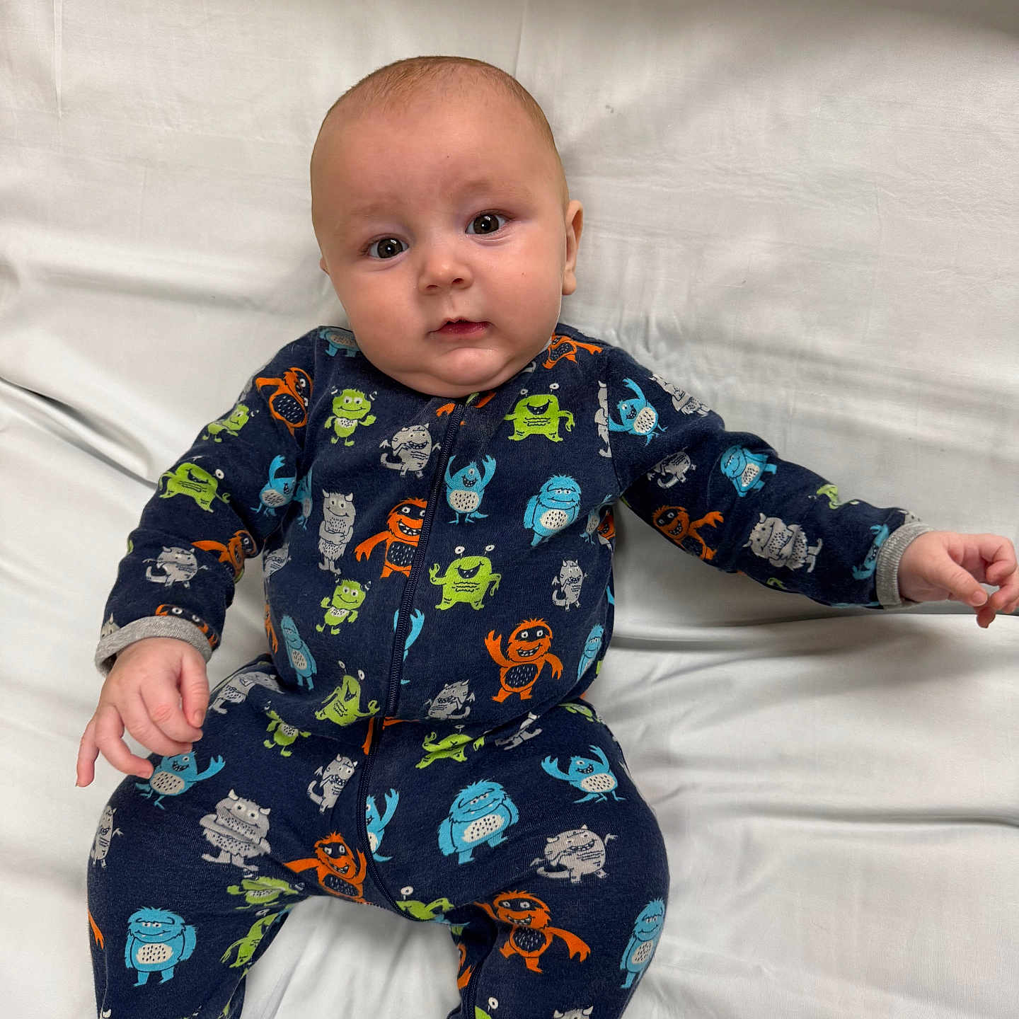 Waylon is registered to the contest to win money with this photo: baby, bed, bodypart, clothing, couch, face, finger, fleece, formalwear, furniture, hand, head, pajamas, pants, person, photography, portrait, suit