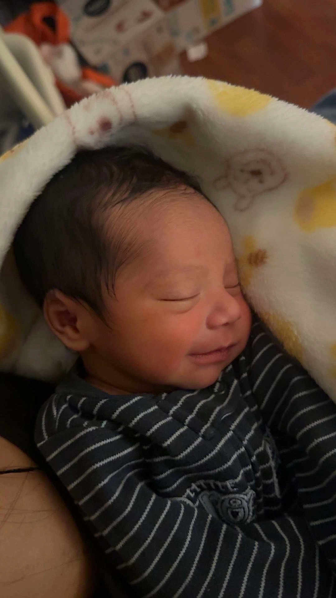 Ivan joined the competition — help win amazing prizes! baby, newborn, infant, sleeping, smiling, blanket, swaddle, striped_outfit, closed_eyes, face, hair, cheek, cozy, soft_texture, portrait, indoor, nursery, fabric_pattern, wood_floor, box