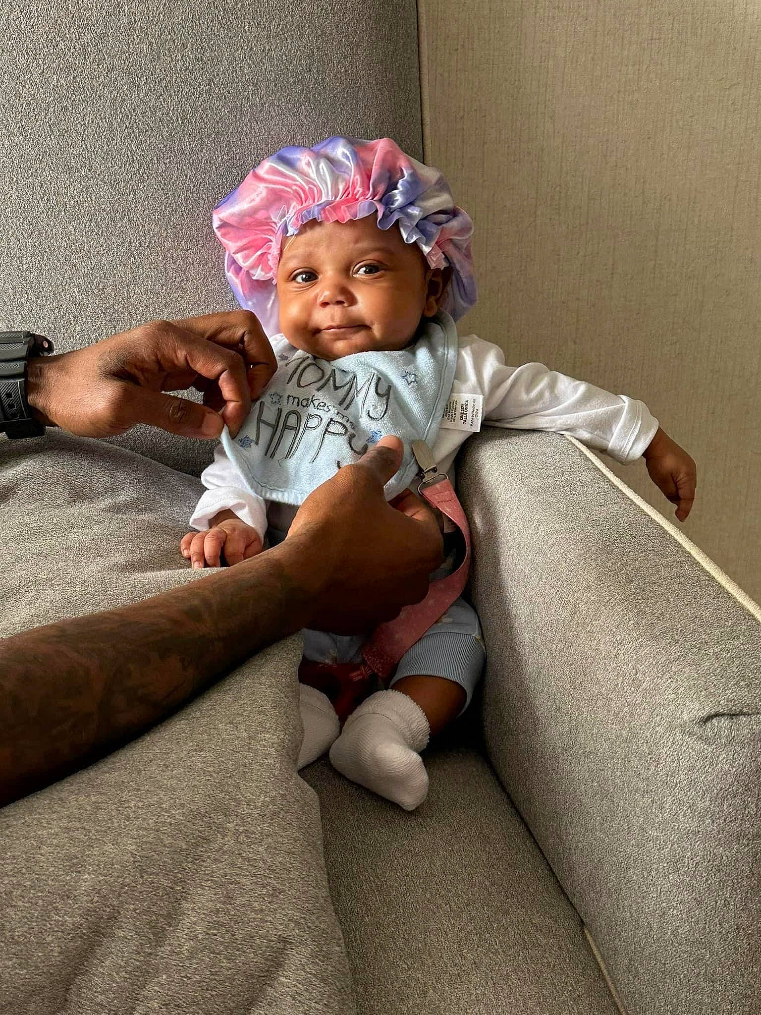 Avianna is registered to the contest to win money with this photo: baby, baby_toddler_clothing, child, comfort, dress, flooring, foot, fun, happy, headwear, human_body, human_leg, lap, linens, magenta, person, room, sitting, sleeve, sock