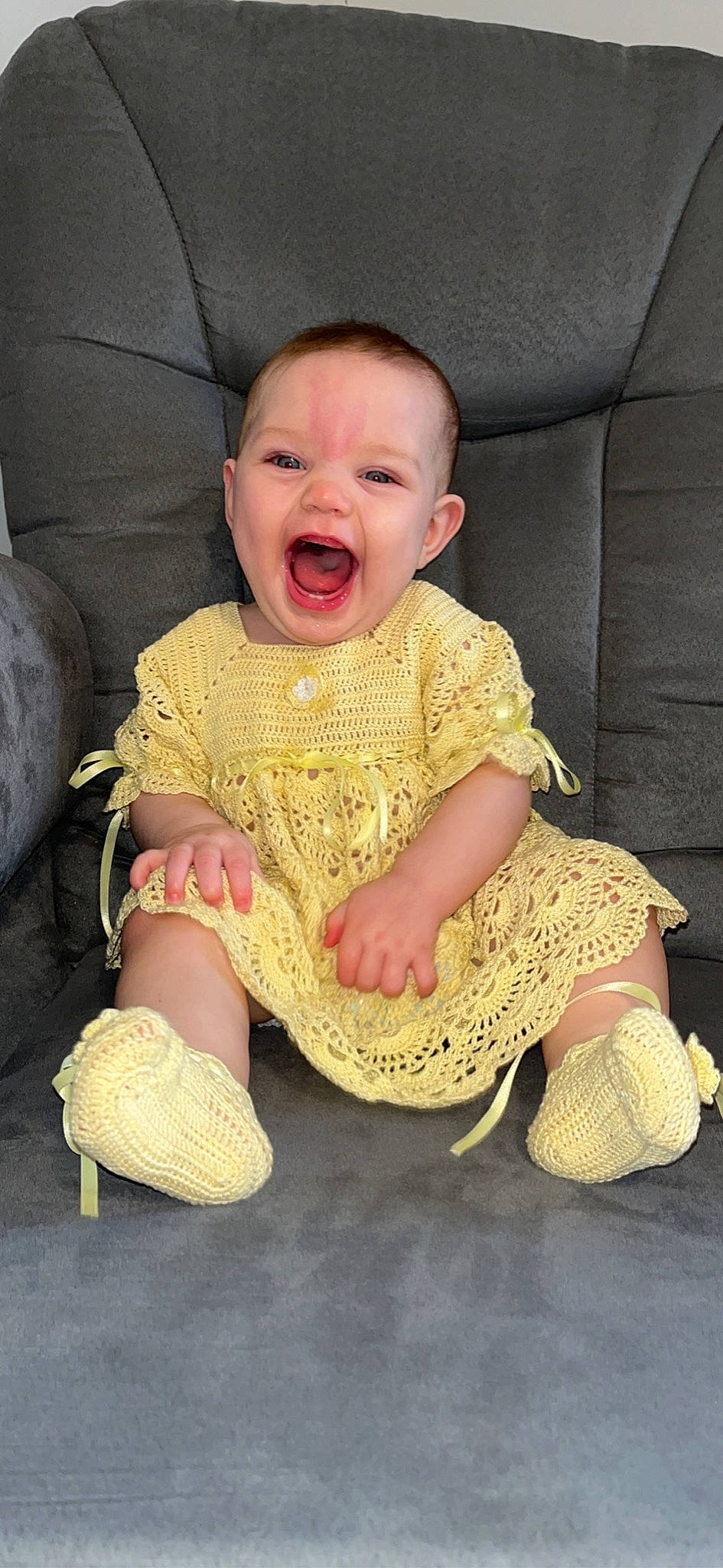 Emma joined the competition — help win amazing prizes! baby, baby_products, baby_toddler_clothing, chair, cheek, child, comfort, couch, dress, eye, fun, happy, head, pattern, person, pink, sitting, sleeve, smile, textile
