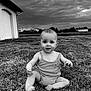 Louise a rejoint le concours — aidez-le/la à gagner de superbes lots ! baby, child, grass, outdoor, cloudy_sky, field, house, onesie, sitting, portrait, curious, nature, daylight, person, barefoot, expression, landscape, young, summer, monochrome